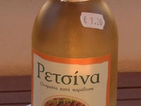 A bottle of white wine, a piece
      of bread and two glasses on the background of clear sky