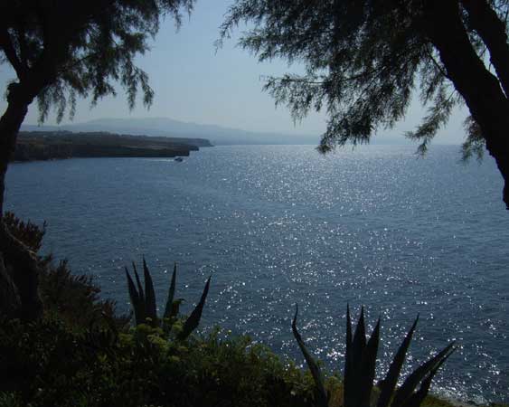 View of sea, sun reflections,
      horizon, far mountains.
