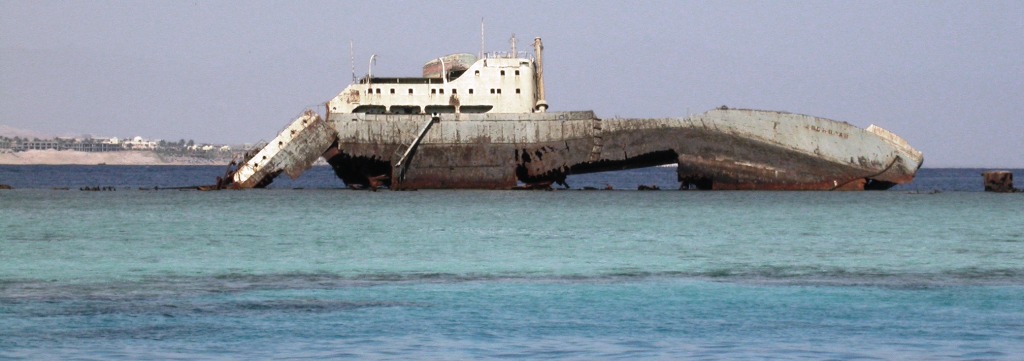 Lullia, rusting ship, washed up on a coral reef