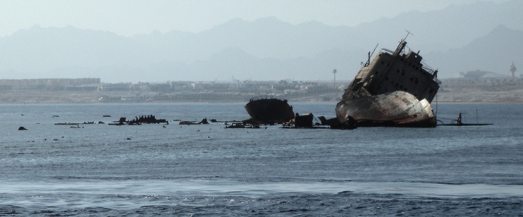 Lullia, rusting ship, washed up on a coral reef