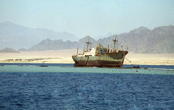 Lullia, rusting ship, washed up on a coral reef